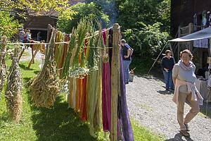 Kräuter und Stoffe hängen auf einer Leine.